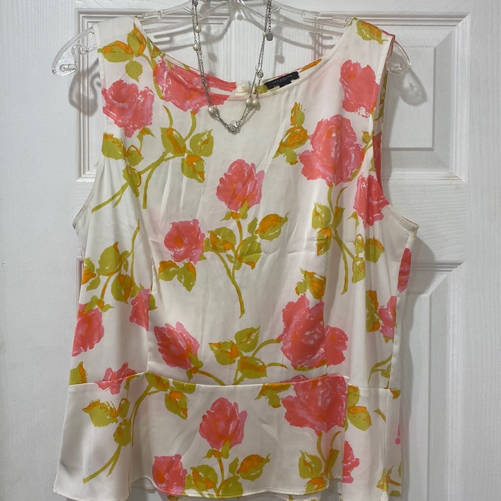 Floral peplum sleeveless blouse. Necklace sold separately